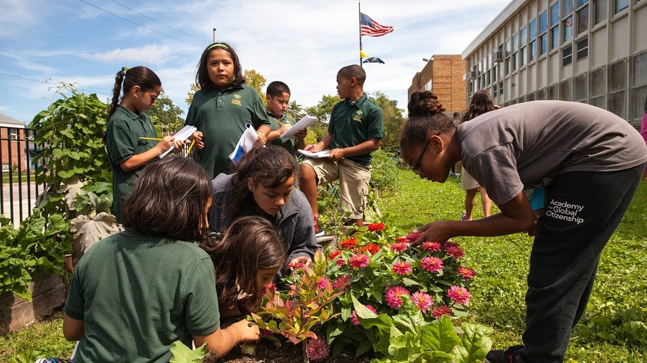 A group of students learns in the garden for the Academy for Global Citizenship Program