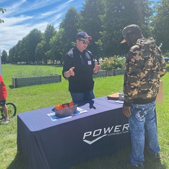 Job recruiting booth, the banner on the table reads "power" as part of the company logo