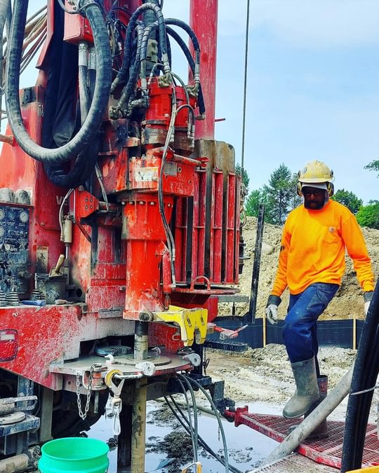 A construction worker operated machinery on the Cultivate Collective build site